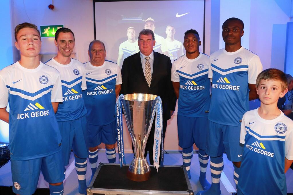 Mick George with Posh players and Johnstones Paint Trophy at kit launch
