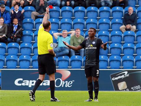Referee Carl Boyeson shows Kgosi Ntlhe a red card v Colchester