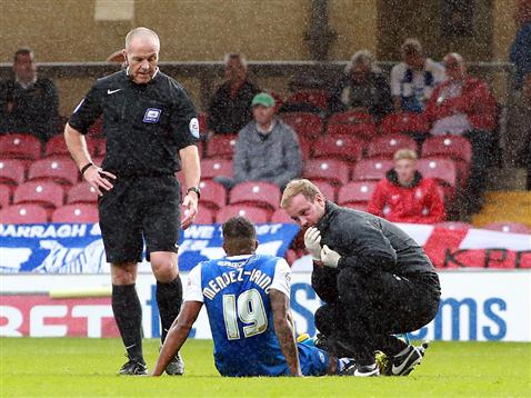 Referee Graham Salisbury watches an injured Nathaniel Mendez-Laing v Bradford