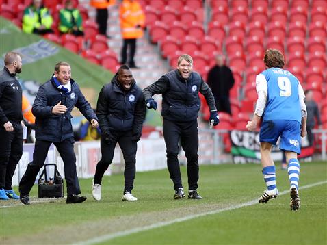 Luke James celebrates with caretaker manager and coaches v Doncaster