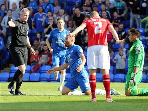 Referee Mark Heywood points to the spot after Michael Bostwick brought down v Walsall
