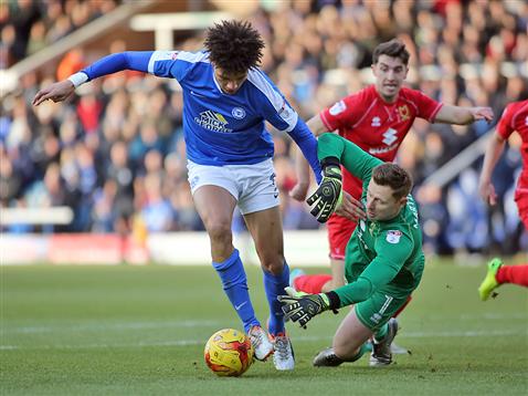 lee-angol-rounds-the-mk-dons-keeper-only-to-see-his-effort-cleared-off-the-line